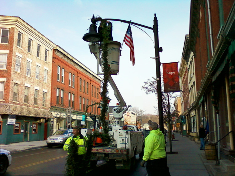 Hanging holiday garlands Main street
